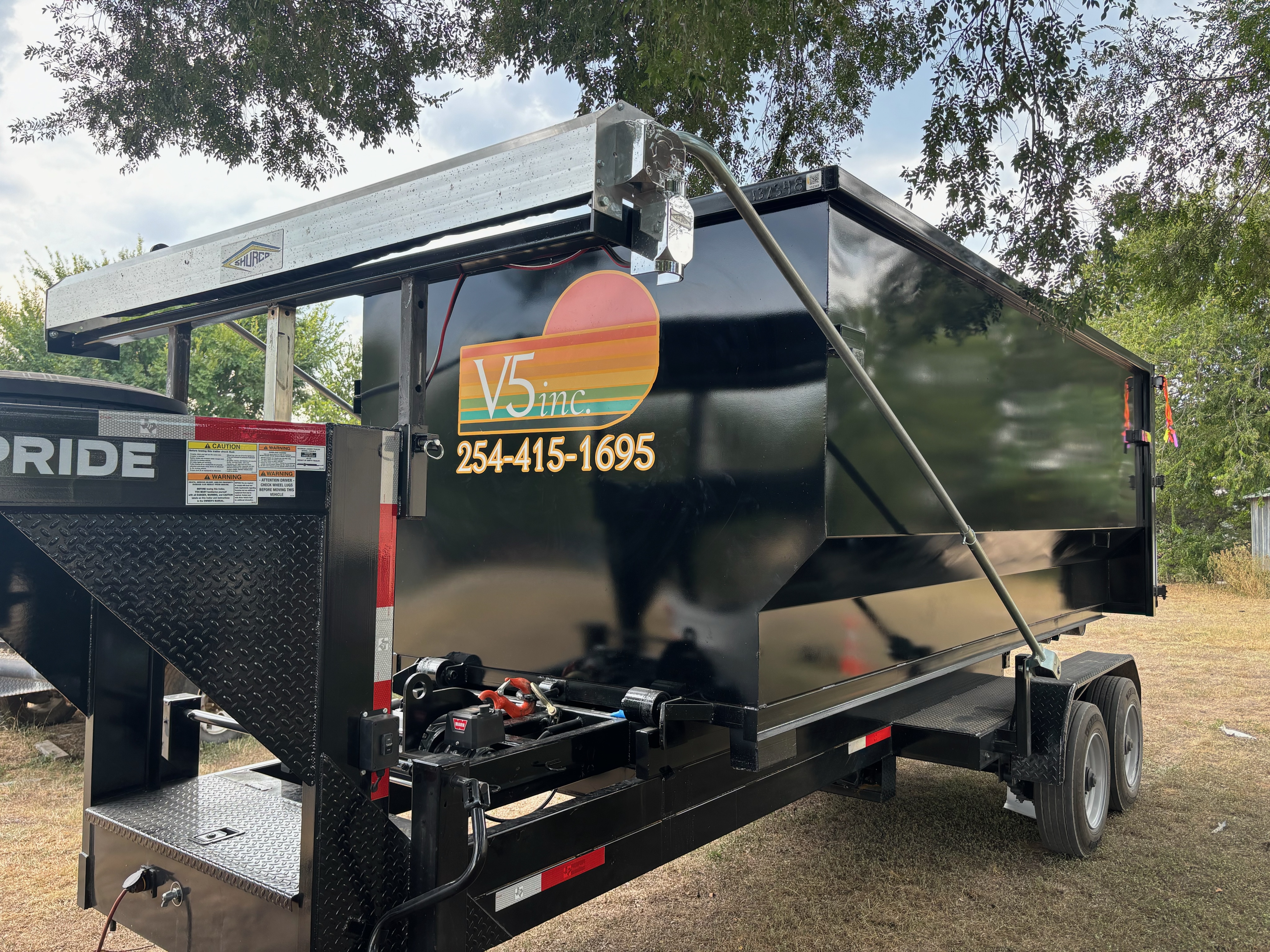 V5 Inc. branded dumpster on trailer — ready for delivery